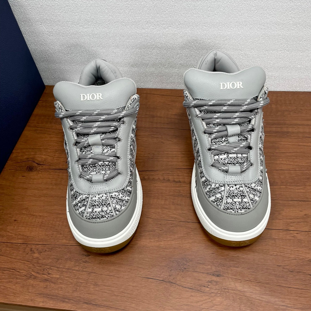 Light gray low-top sneakers with lace-up closure and Dior logo on tongue