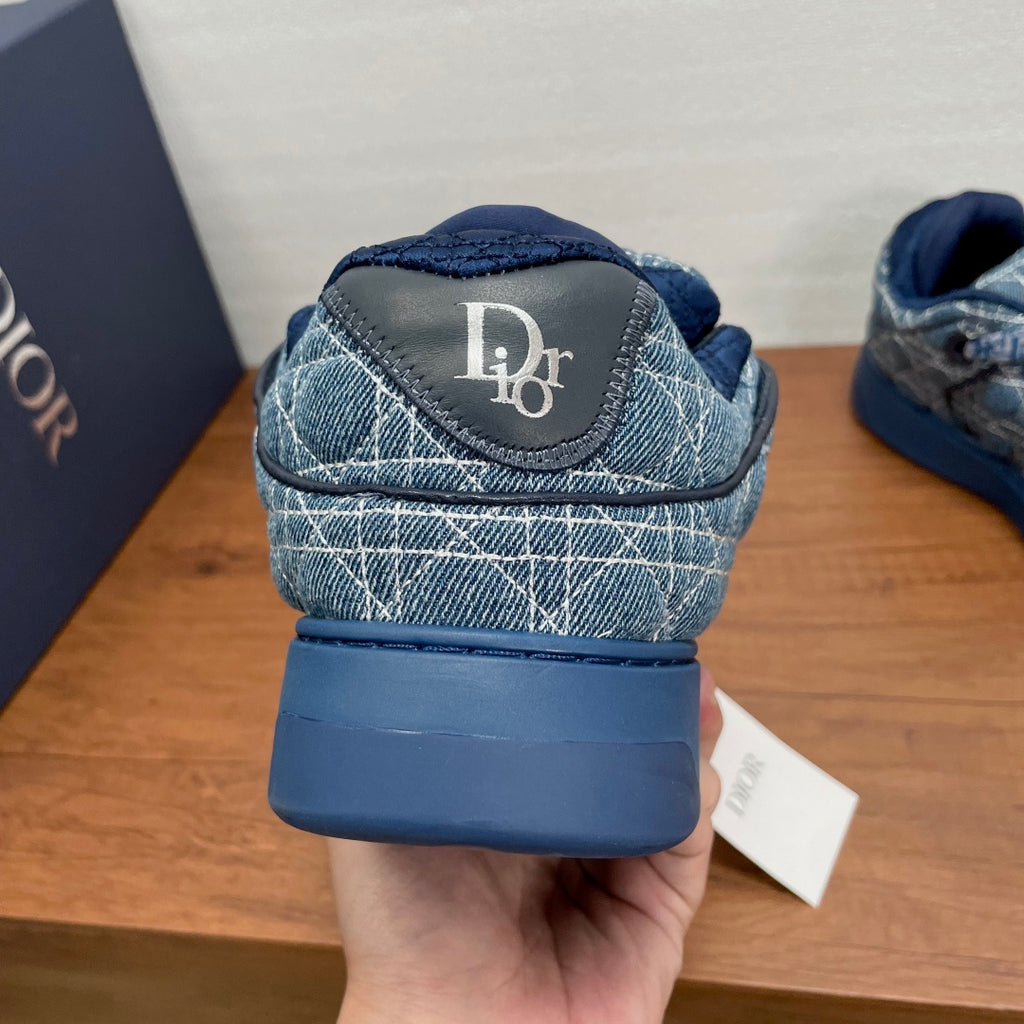 Unisex Dior sneakers, blue denim heel with Dior logo patch, close-up