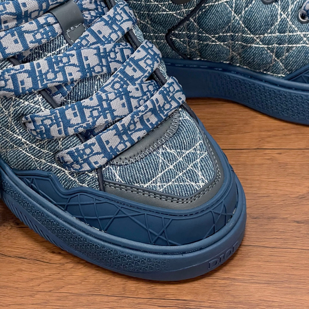 Dior unisex sneaker side detail, blue strap with repeating Dior pattern and tread sole