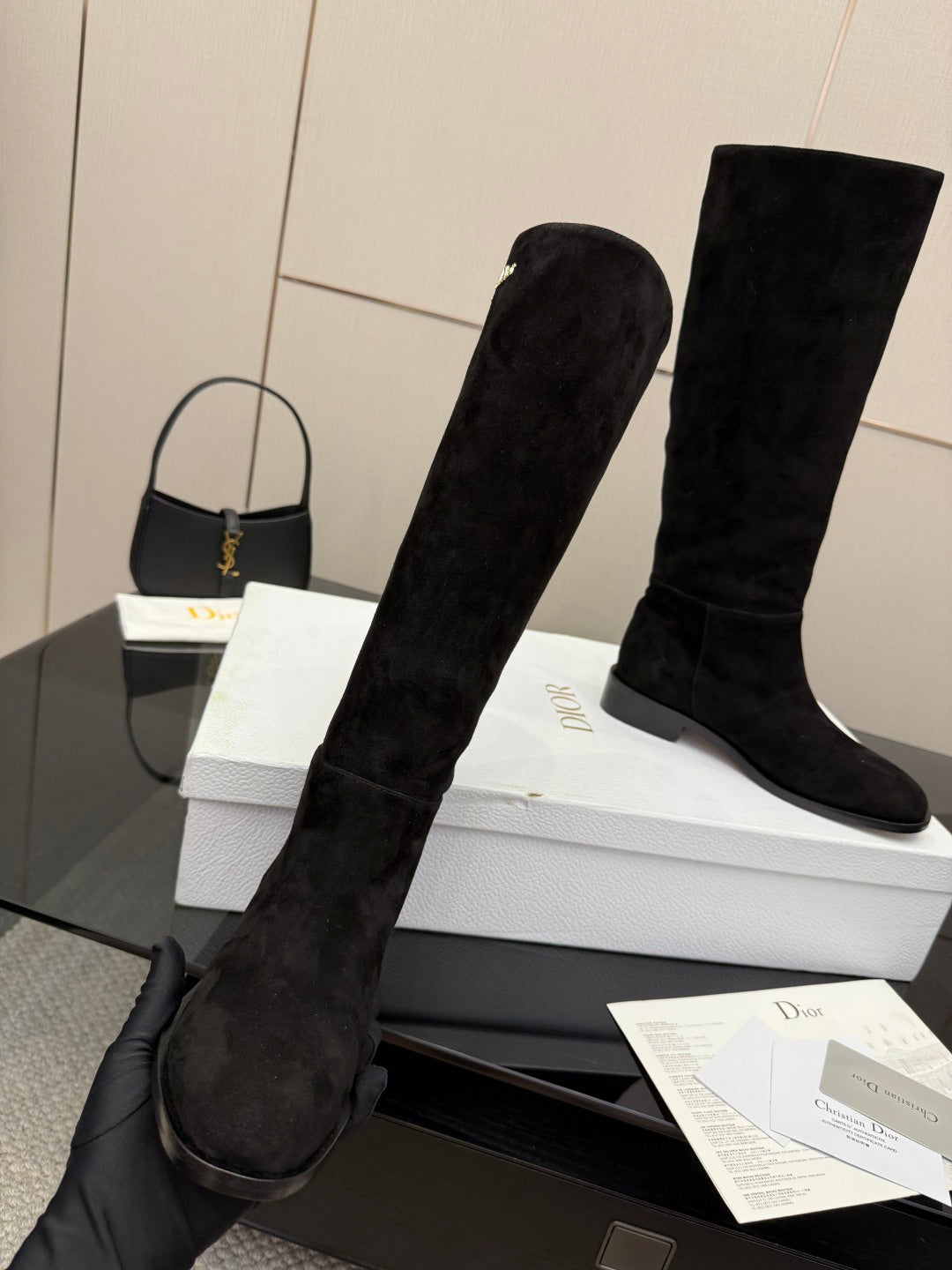Black knee-high suede boots with mid block heel, shown at an angled side view
