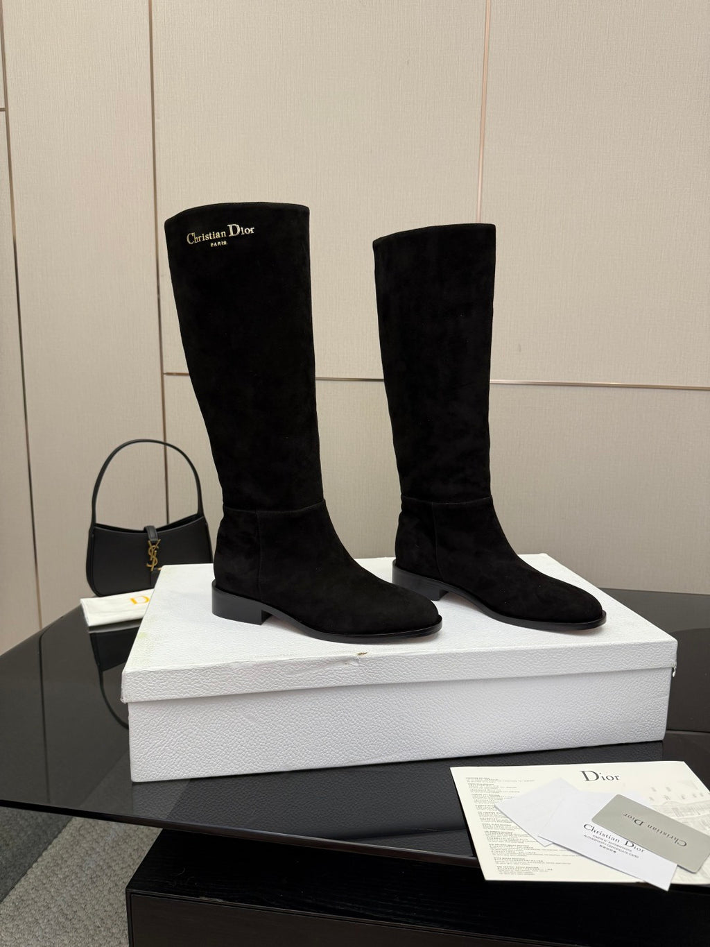Pair of knee-high suede boots in black with mid block heel and pull-on design