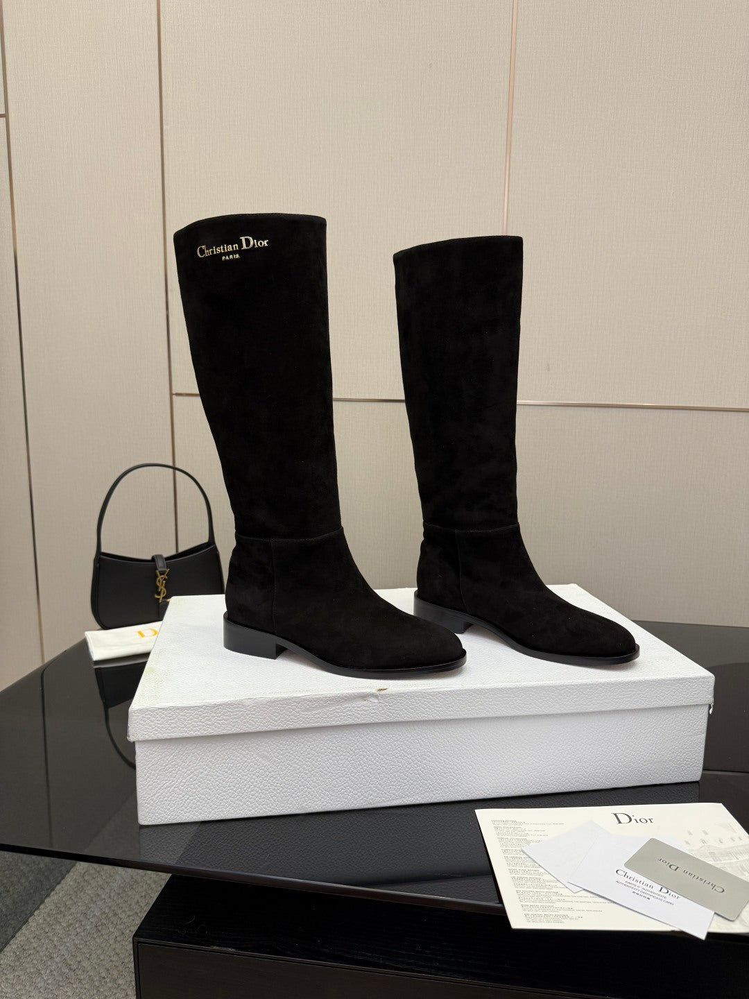 Pair of knee-high suede boots in black with mid block heel and pull-on design
