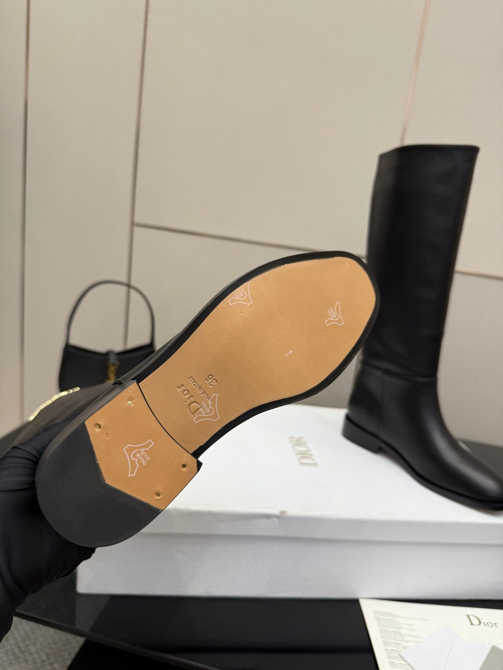 Boot outsole view with gold patterned insole and logo on footbed
