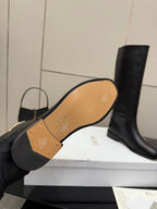 Boot outsole view with gold patterned insole and logo on footbed