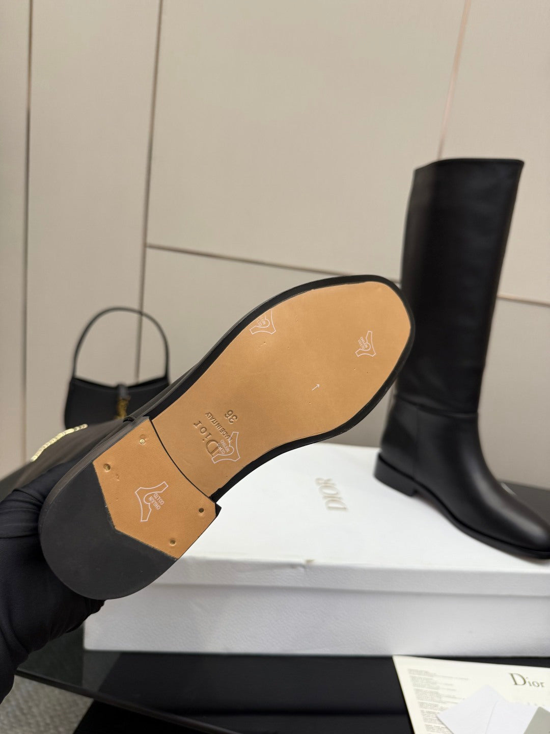 Boot outsole view with gold patterned insole and logo on footbed