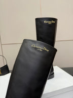 Black leather knee-high boot with embossed Christian Dior text on shaft