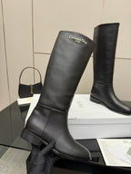Black leather knee-high boots, angled view with heel and side seam