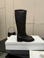 Black leather knee-high boot, pull-on style with logo at top