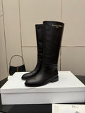 Black leather knee-high boots with low block heel and stitched toe