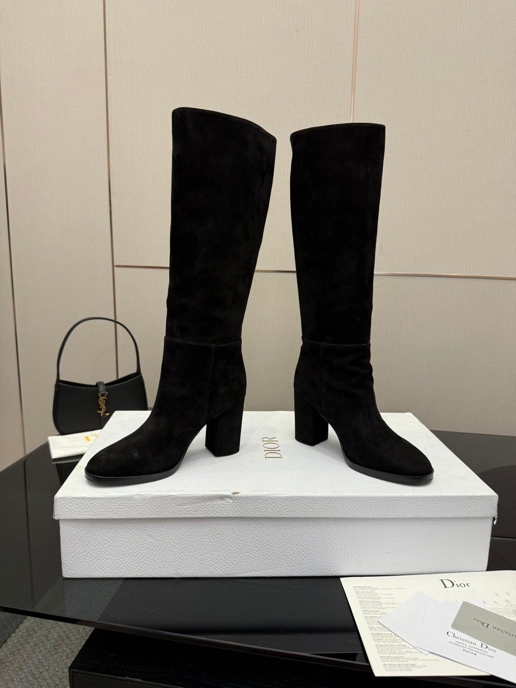Black knee-high suede boots with stacked block heels and pull-on design