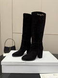 Pair of black knee-high suede boots with chunky heels and pull-on shafts