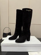 Pair of black knee-high suede boots with chunky heels and pull-on shafts