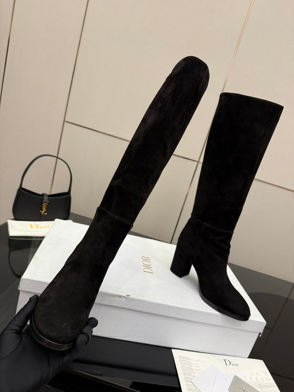 Pair of black knee-high suede boots with pull-on shafts and block heels