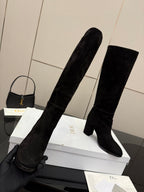 Pair of black knee-high suede boots with pull-on shafts and block heels