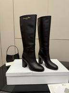 Pair of black knee-high boots with mid chunky heel and pull tab, Dior branding