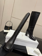Black knee-high boots with block heel, angled view, pull-on design