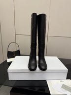 Black knee-high boots standing side by side, block heel, pull-on style, Dior logo
