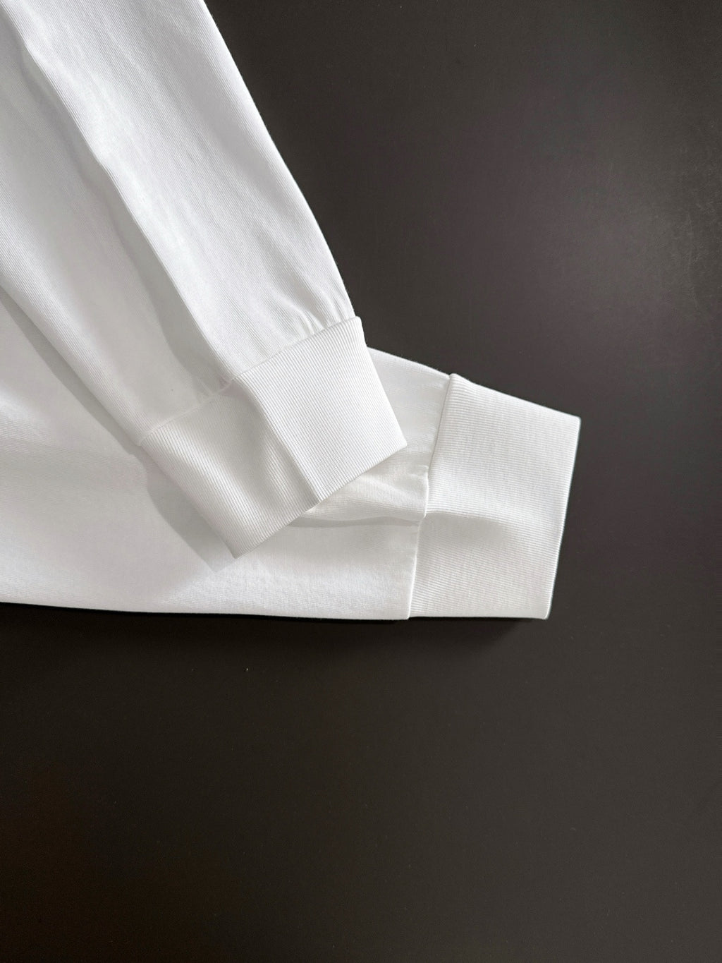 White long-sleeve shirt cuff and seam detail