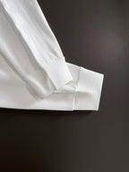 White long-sleeve shirt cuff and seam detail