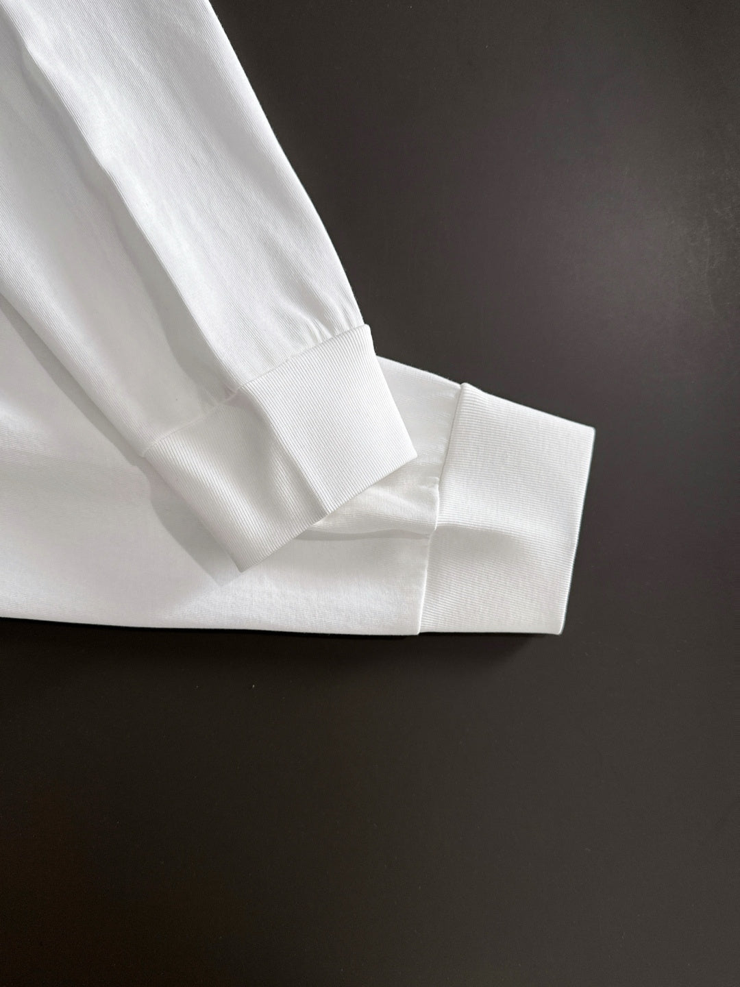White long-sleeve shirt cuff and seam detail