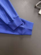 Prada blue long-sleeve top cuff and hem detail