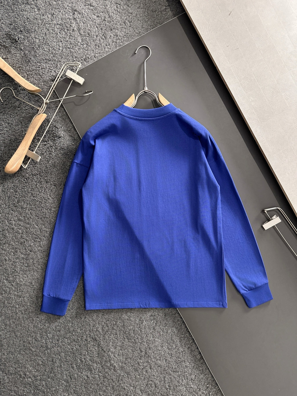 Prada long-sleeve top, blue back view on hanger