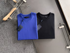 Prada long-sleeve tops, blue and black, on display hangers