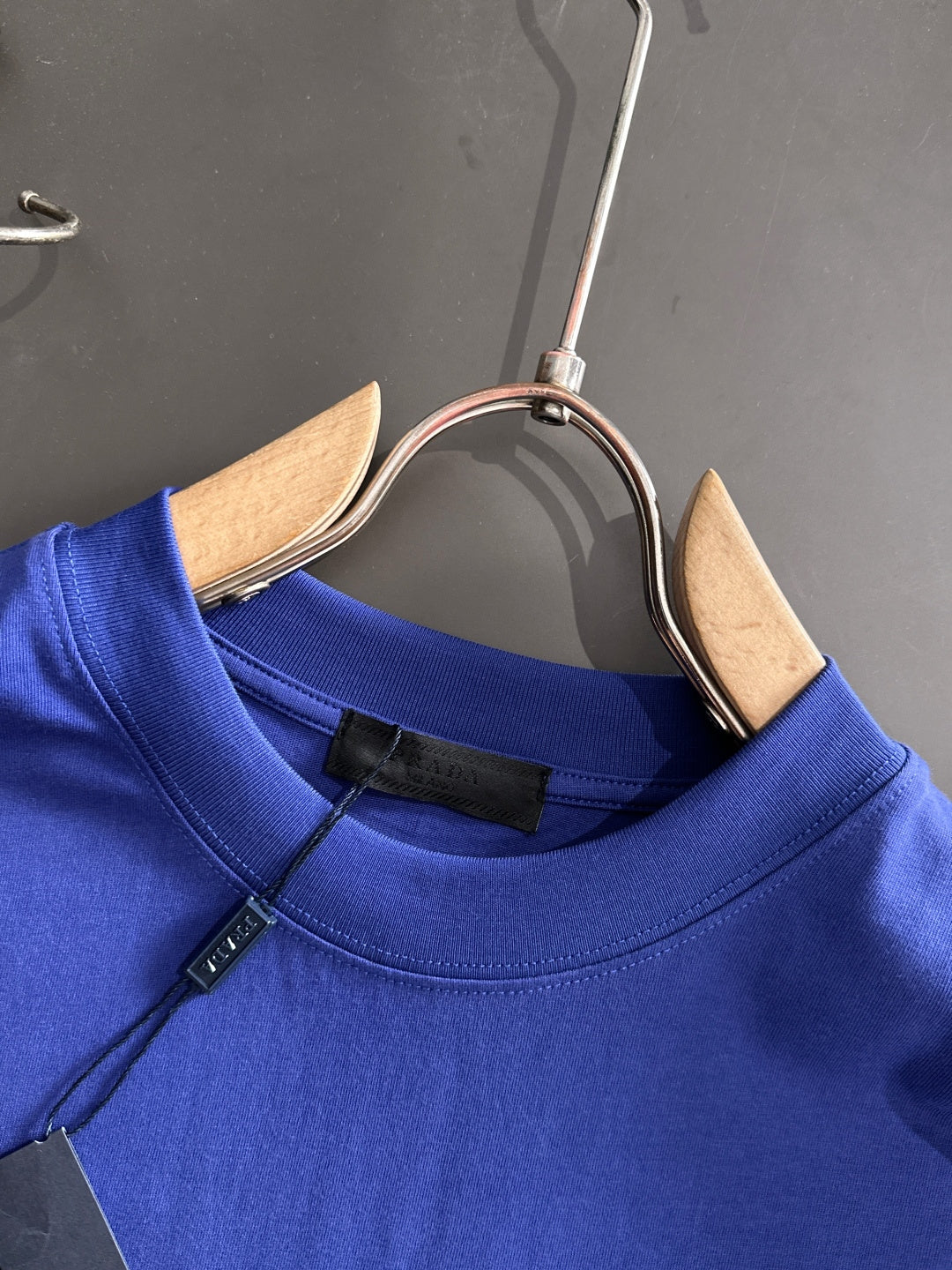 Prada blue long-sleeve top neckline with buttoned placket detail