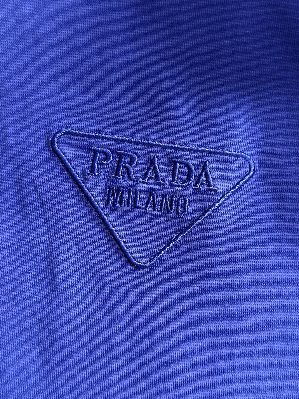 Prada MILANO embroidered triangle logo on blue long-sleeve top