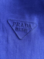 Prada MILANO embroidered triangle logo on blue long-sleeve top