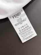 Care label tag on white long-sleeve shirt with FENDI branding