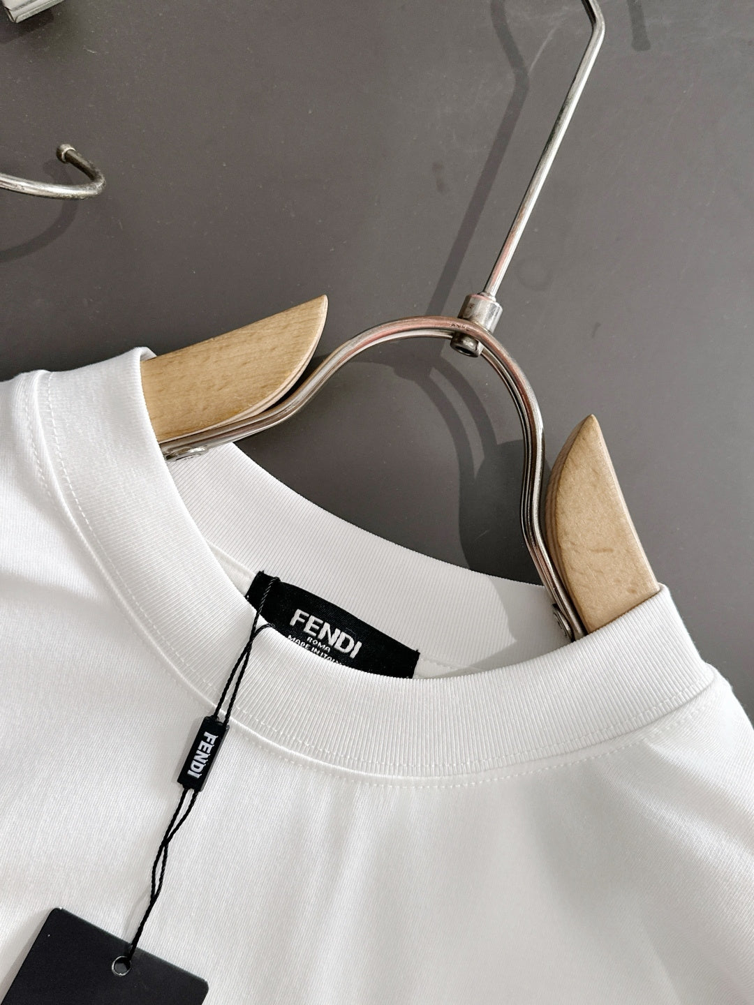 White long-sleeve shirt neckline with FENDI inner label and hanging tag