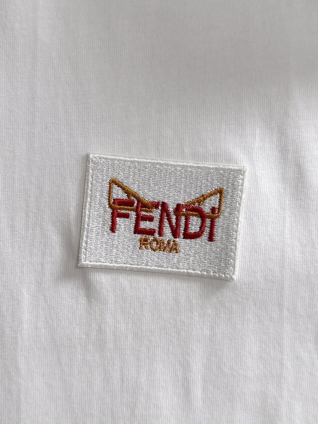 White fabric label patch with FENDI ROMA logo