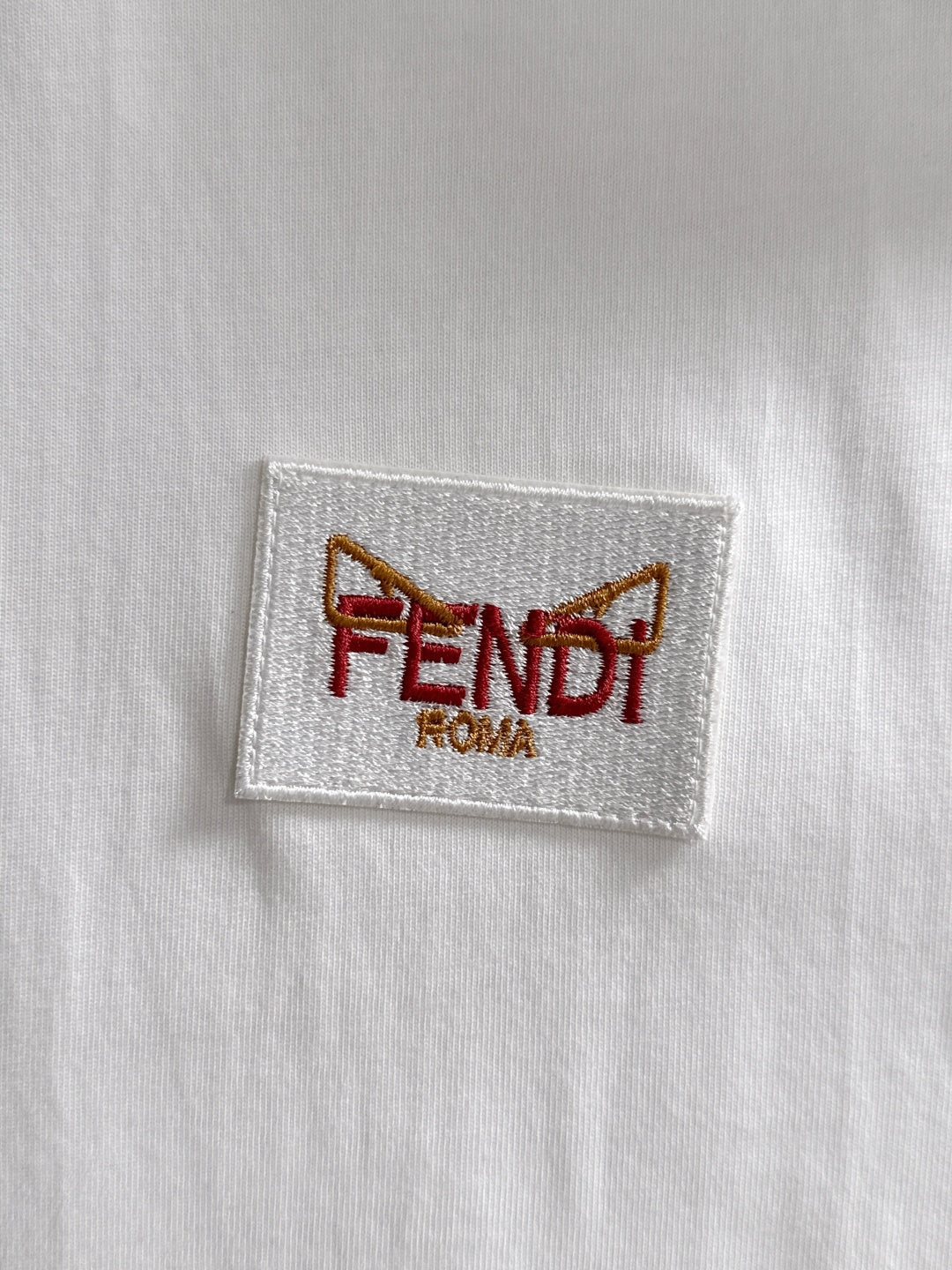 White fabric label patch with FENDI ROMA logo