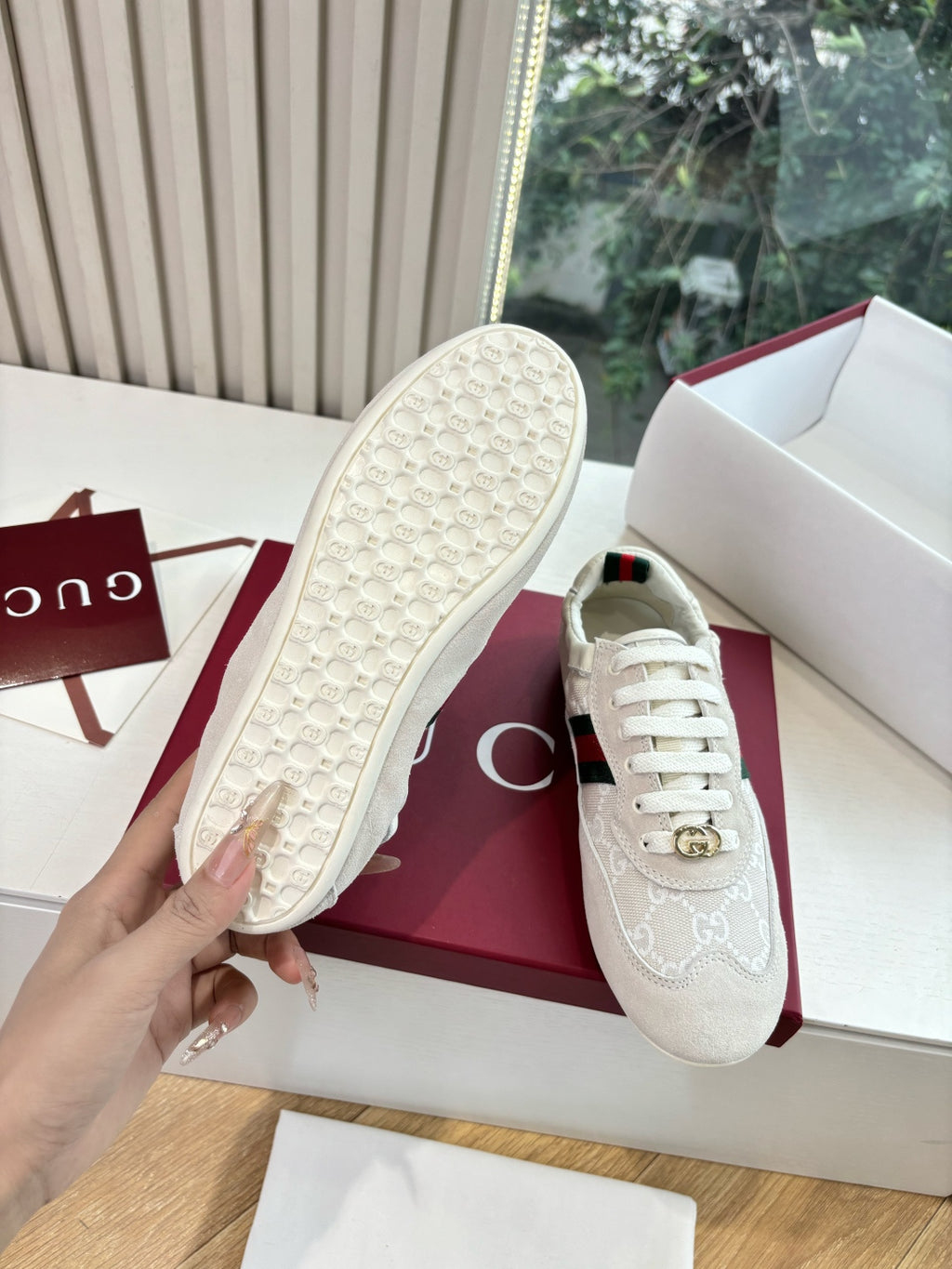 Gucci low-top sneaker sole view, textured rubber outsole on white shoe