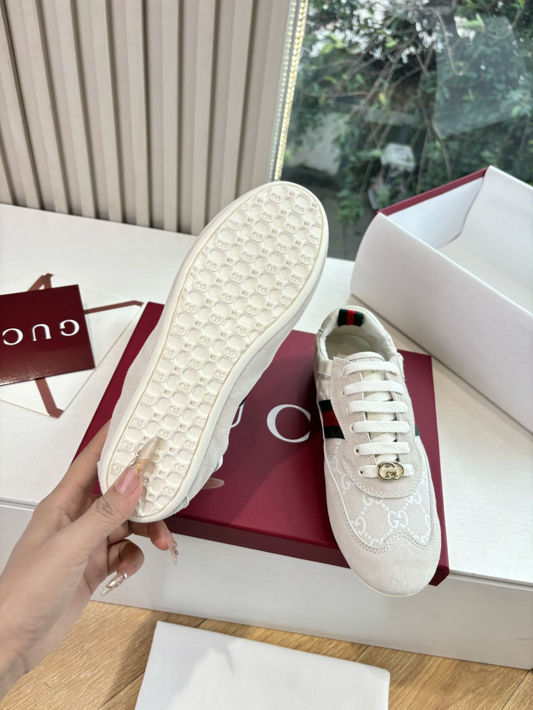 Gucci low-top sneaker sole view, textured rubber outsole on white shoe