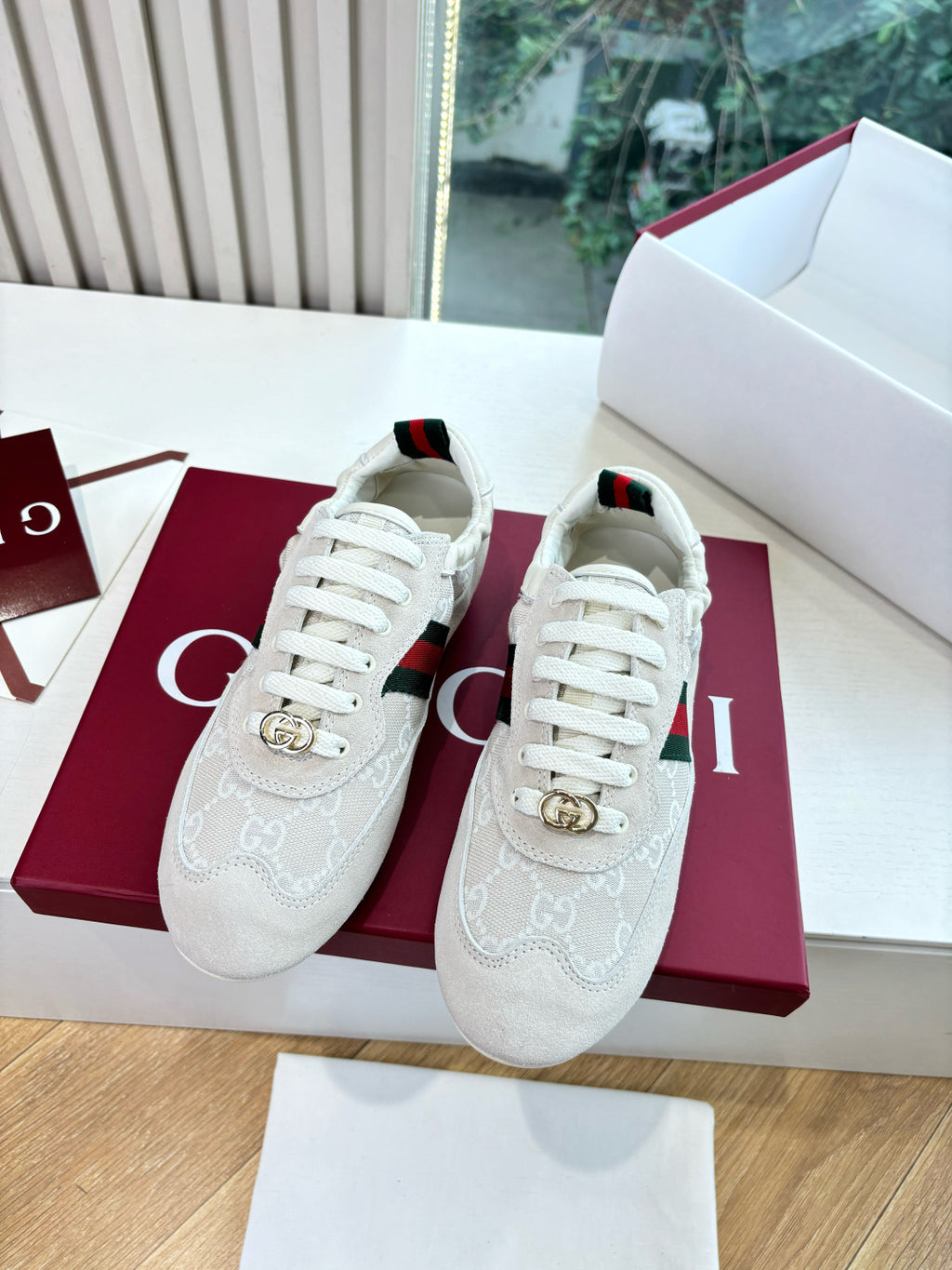 Gucci low-top sneakers pair, white GG pattern with green-red side stripe and gold horsebit