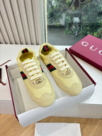 Women's yellow low-top sneakers with Web stripe and logo lace hardware