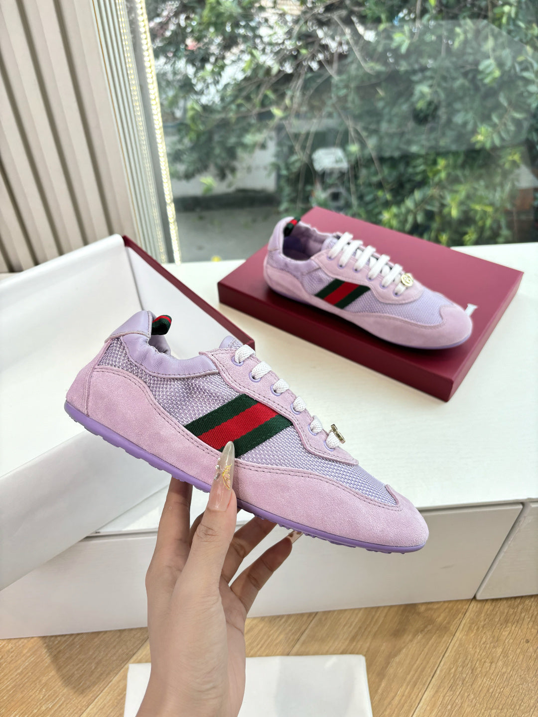 Lilac Gucci ladies sneakers on display with green-red side stripe and white laces