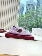 Lilac Gucci ladies sneakers on red box, with green-red side stripe and white laces