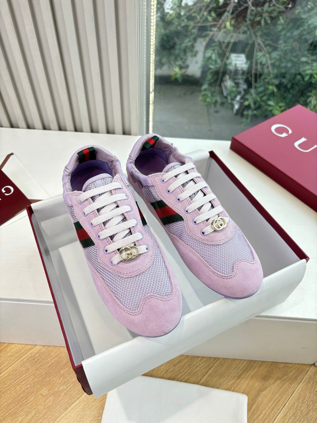 Lilac Gucci ladies sneakers with white laces and gold emblem on side