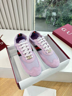 Lilac Gucci ladies sneakers with white laces and gold emblem on side