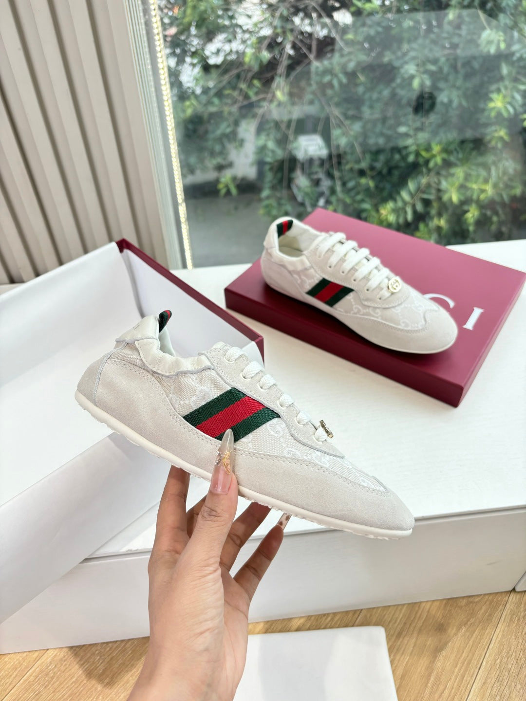 Gucci low-top sneakers, white upper with green-red web stripe and gold logo lace charm