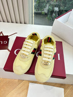 Women's yellow low-top sneakers with Web stripe and round logo charm