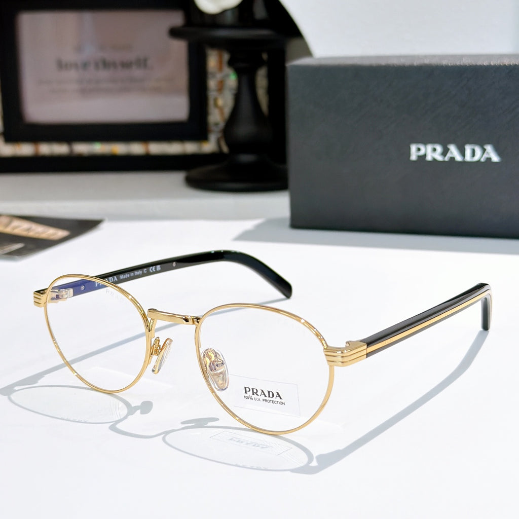 Gold round eyeglasses with black temple arms and clear lenses