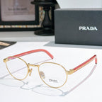 Gold round eyeglasses with red temple arms and clear lenses