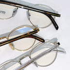 Round eyeglasses with clear lenses and black-and-gold temple tips
