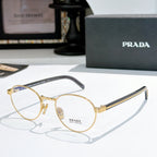 Gold round eyeglasses with dark blue temple arms and clear lenses