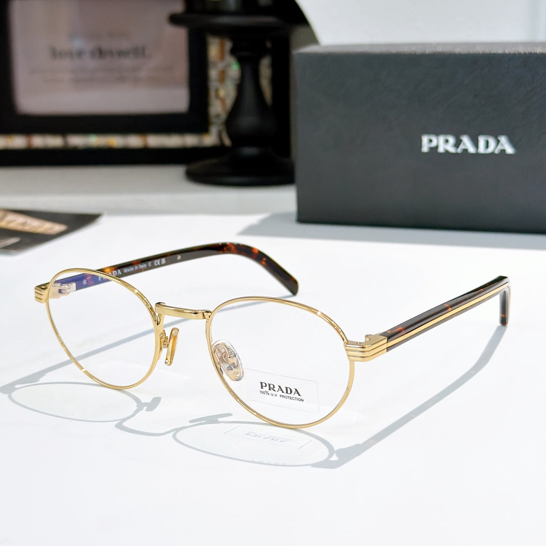 Gold round eyeglasses with tortoiseshell temple arms and clear lenses