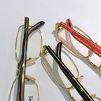 Glasses frames with gold, black, and red striped temple arms